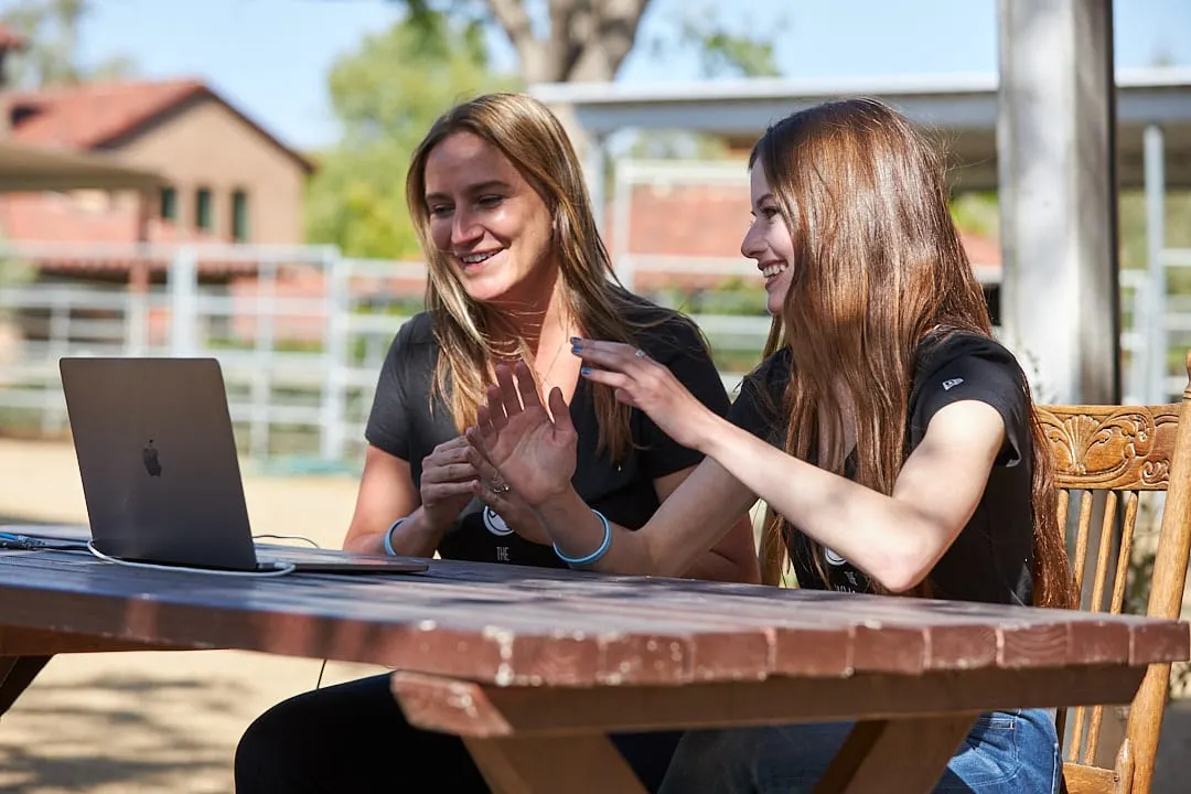 Ashley Avis and Mackenzie Foy laughing with the children from St. Jude