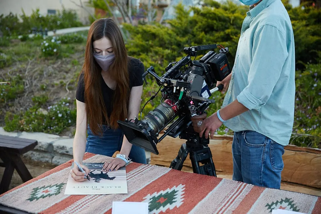 Behind the scenes filming Mackenzie Foy sign Black Beauty posters